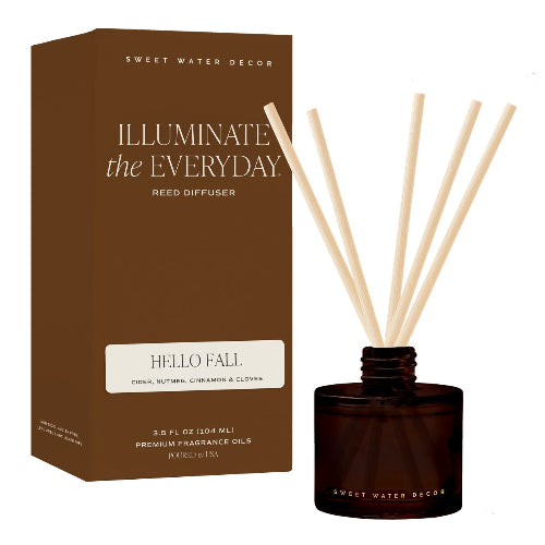 Sweet Water Decor 'Illuminate the Everyday' Pumpkin Spice reed diffuser, showing the brown branded box next to the amber glass bottle with natural reed sticks, on a white background.