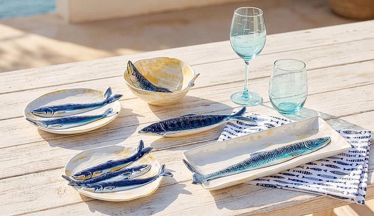 Abbott blue and yellow fish dishes styled on an outdoor table
