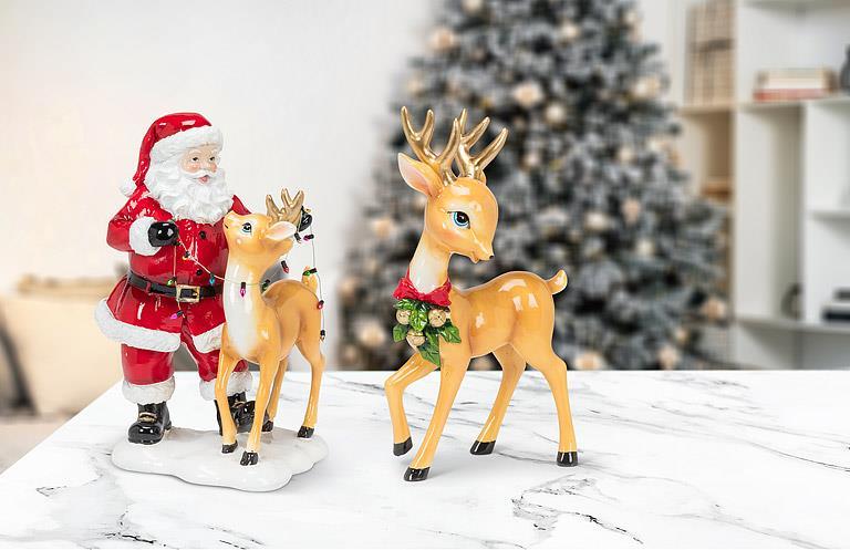 Abbott standing reindeer with bow in a holiday scene with Santa and a Christmas tree