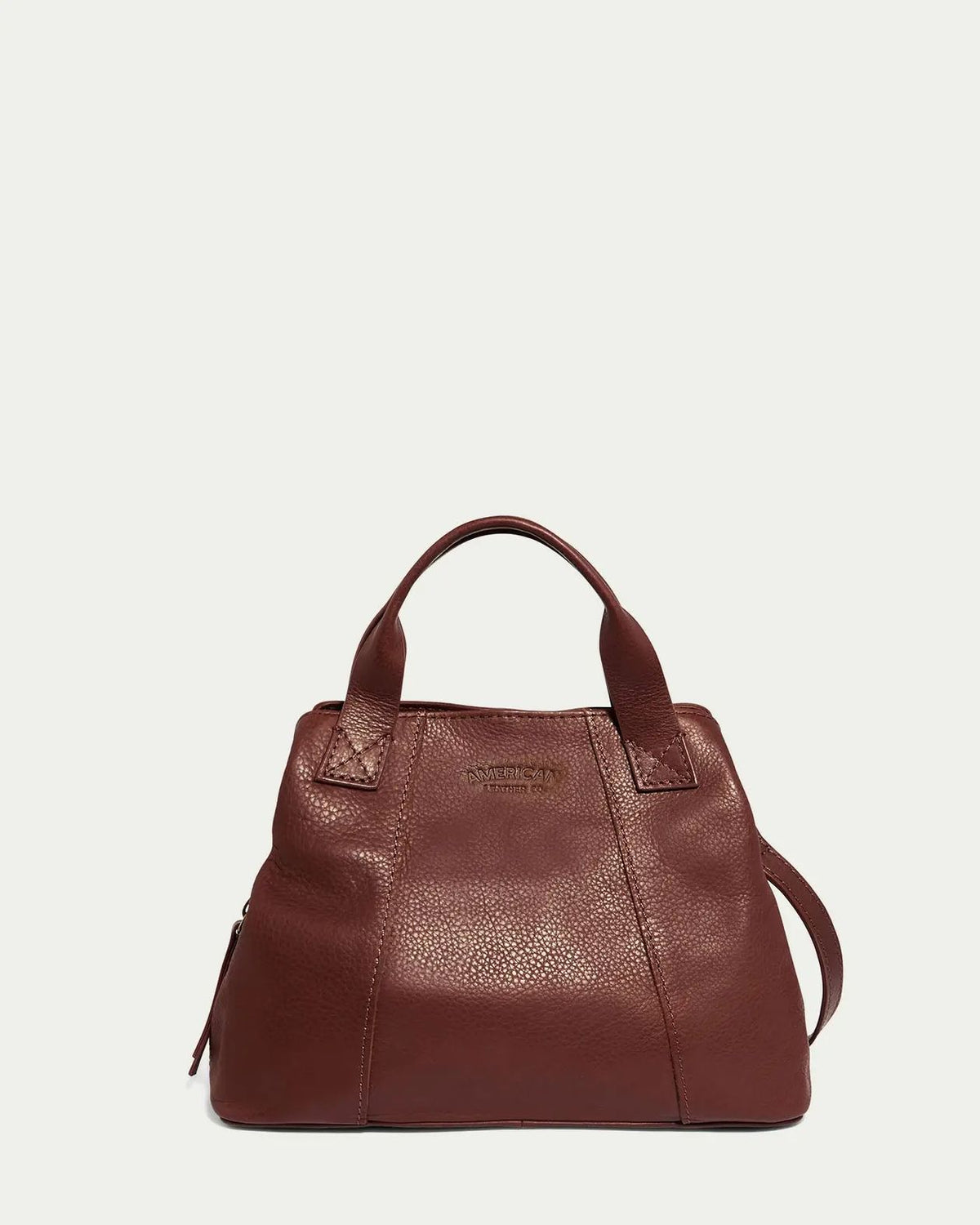 Brown leather handbag on a light gray background