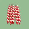 Five red and white striped candy canes with silver metal tops, arranged in a fan shape against a solid light green background.