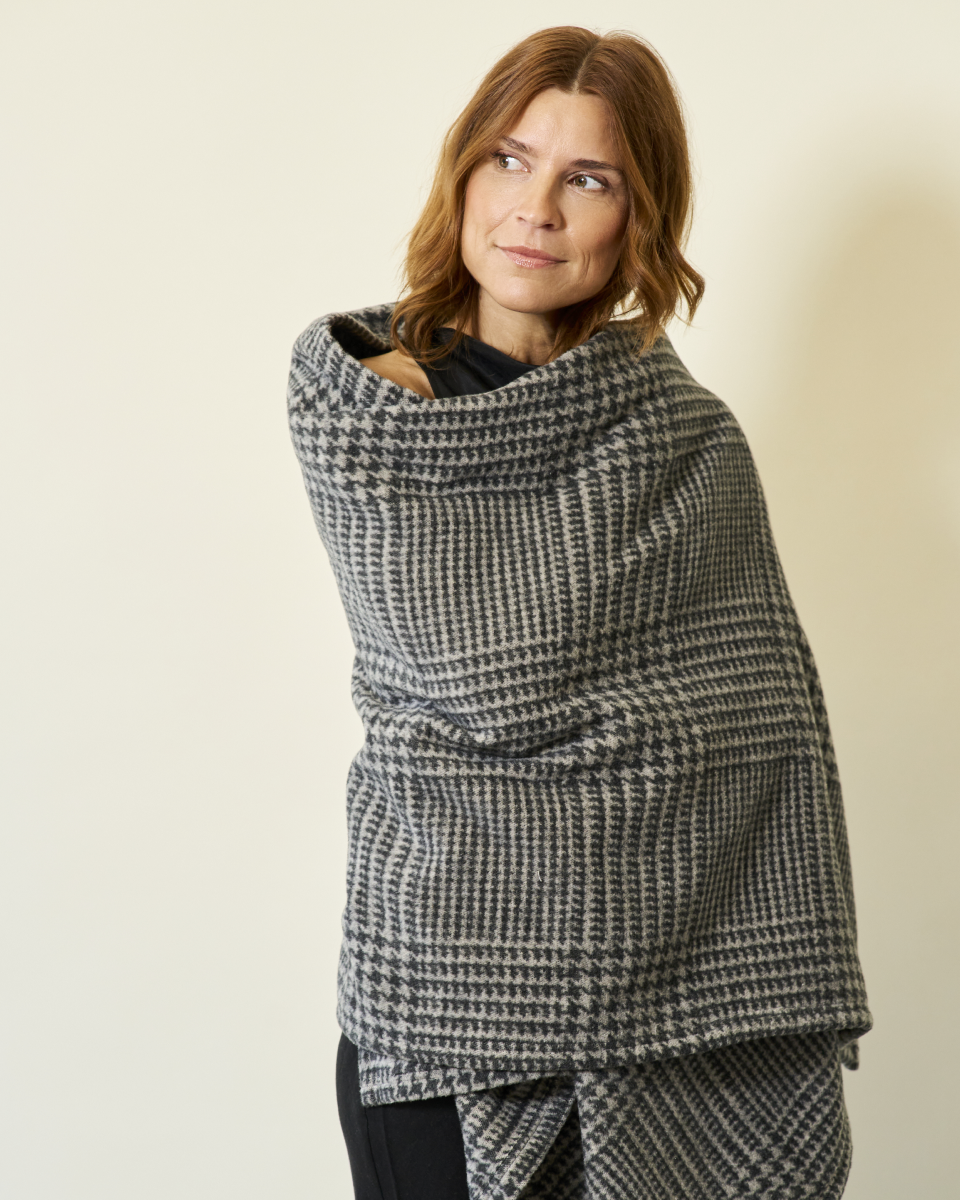 Woman wearing the Chappywrap Katama Plaid Shawl in Ash wrapped around her shoulders