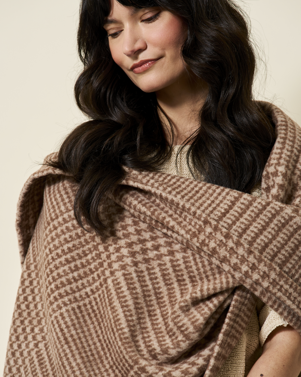 Woman wearing the Chappywrap Katama Plaid Shawl in Chocolate draped over one shoulder