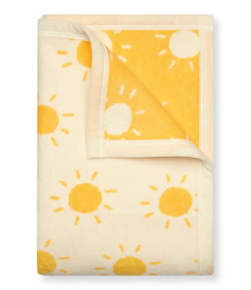 Folded blanket with sun pattern on a white background
