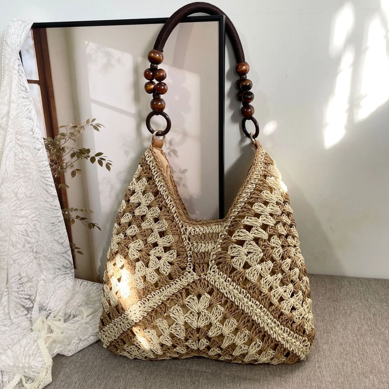 Crocheted handbag with wooden handle on a neutral background