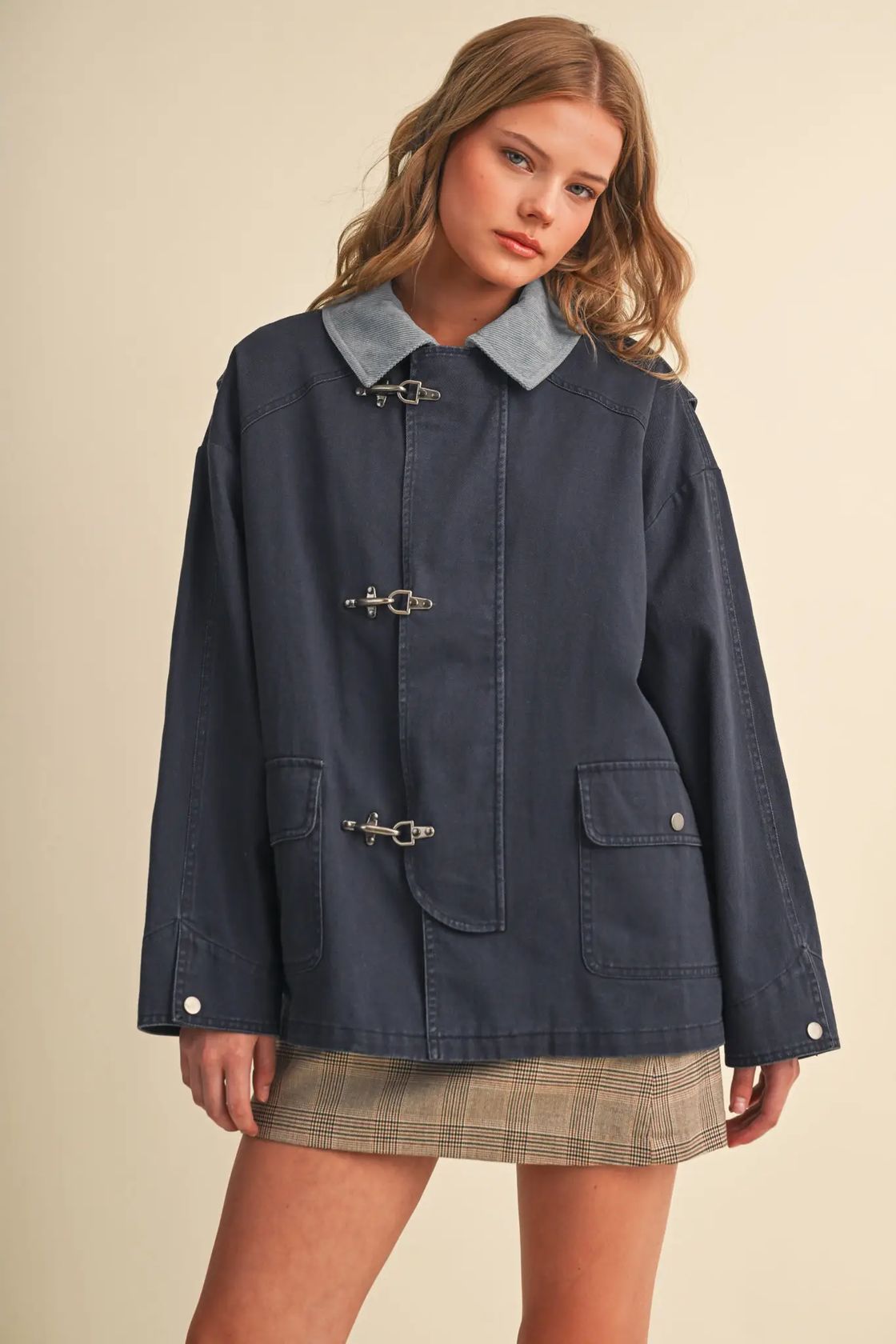 Woman wearing the &merci Denim Utility Jacket in indigo with a light-blue corduroy collar and clip-clasp closures, front view