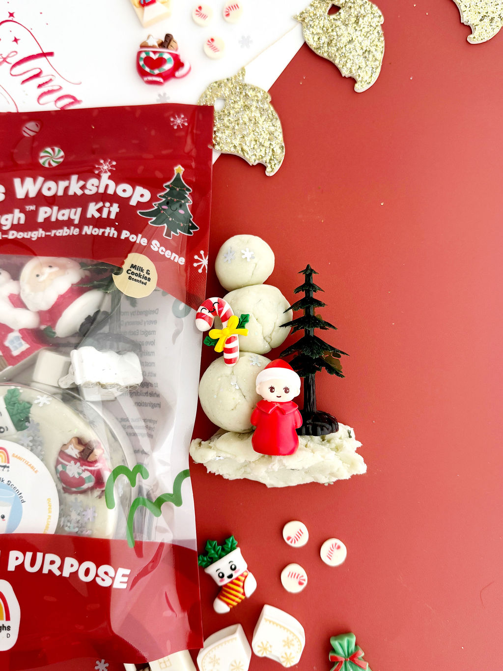 Earth Grown KidDoughs Santa's Workshop KidDough Play Kit contents spread out: play dough, Santa figure and holiday accessories