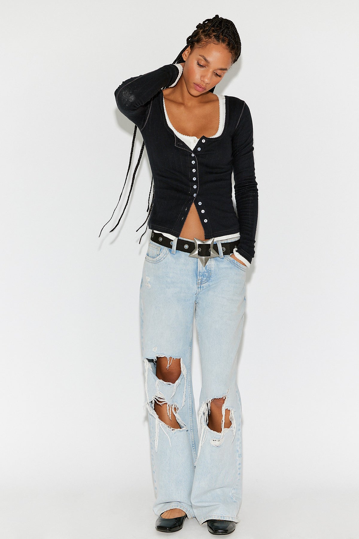 Model wearing the black End Game Pointelle Long Sleeve with distressed light-wash jeans