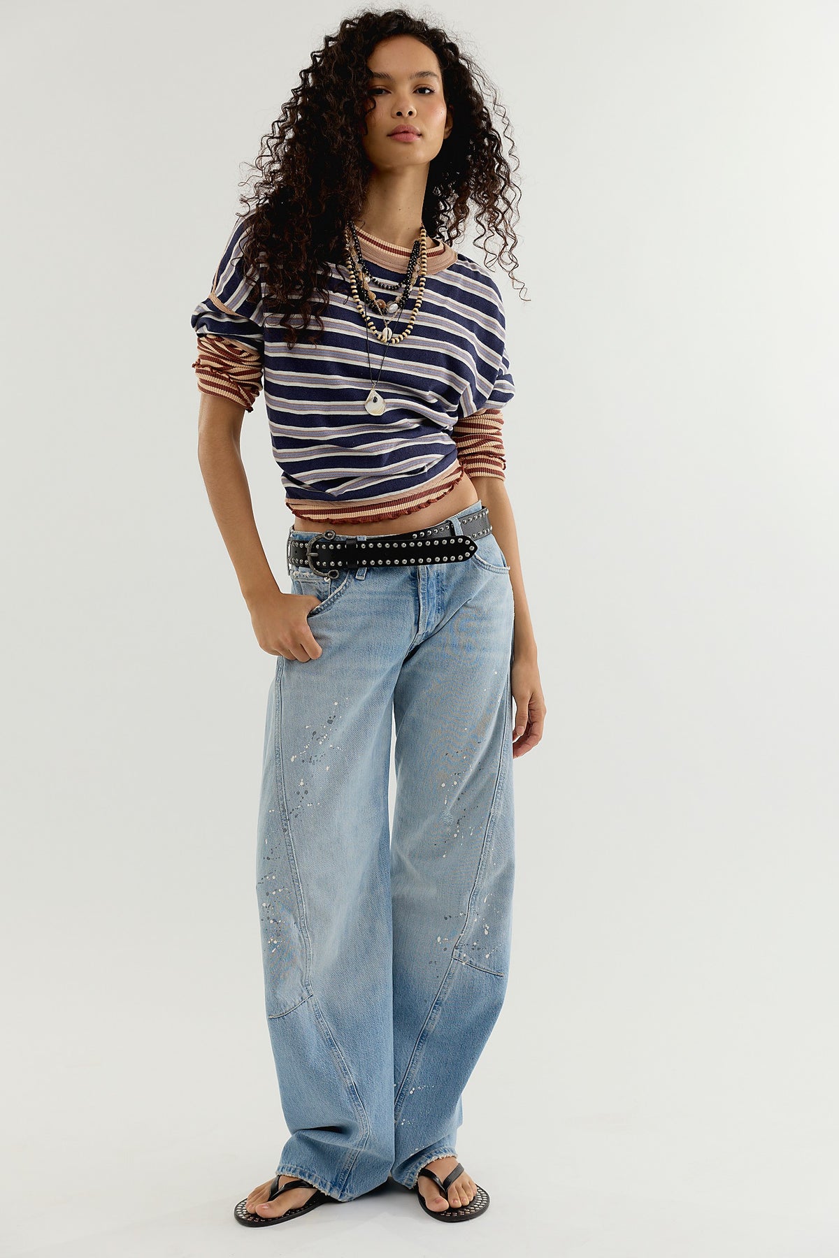 Side view of the Fable Twisted Seam Jean in Art School showing the arced barrel leg