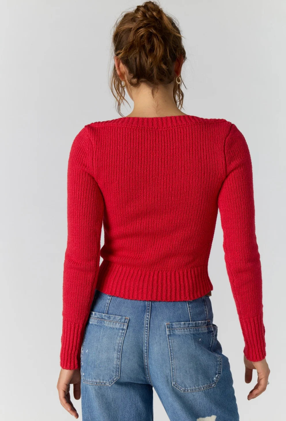 Back view of the Free People Mila Pullover in salsa red showing the fitted ribbed knit and cropped length
