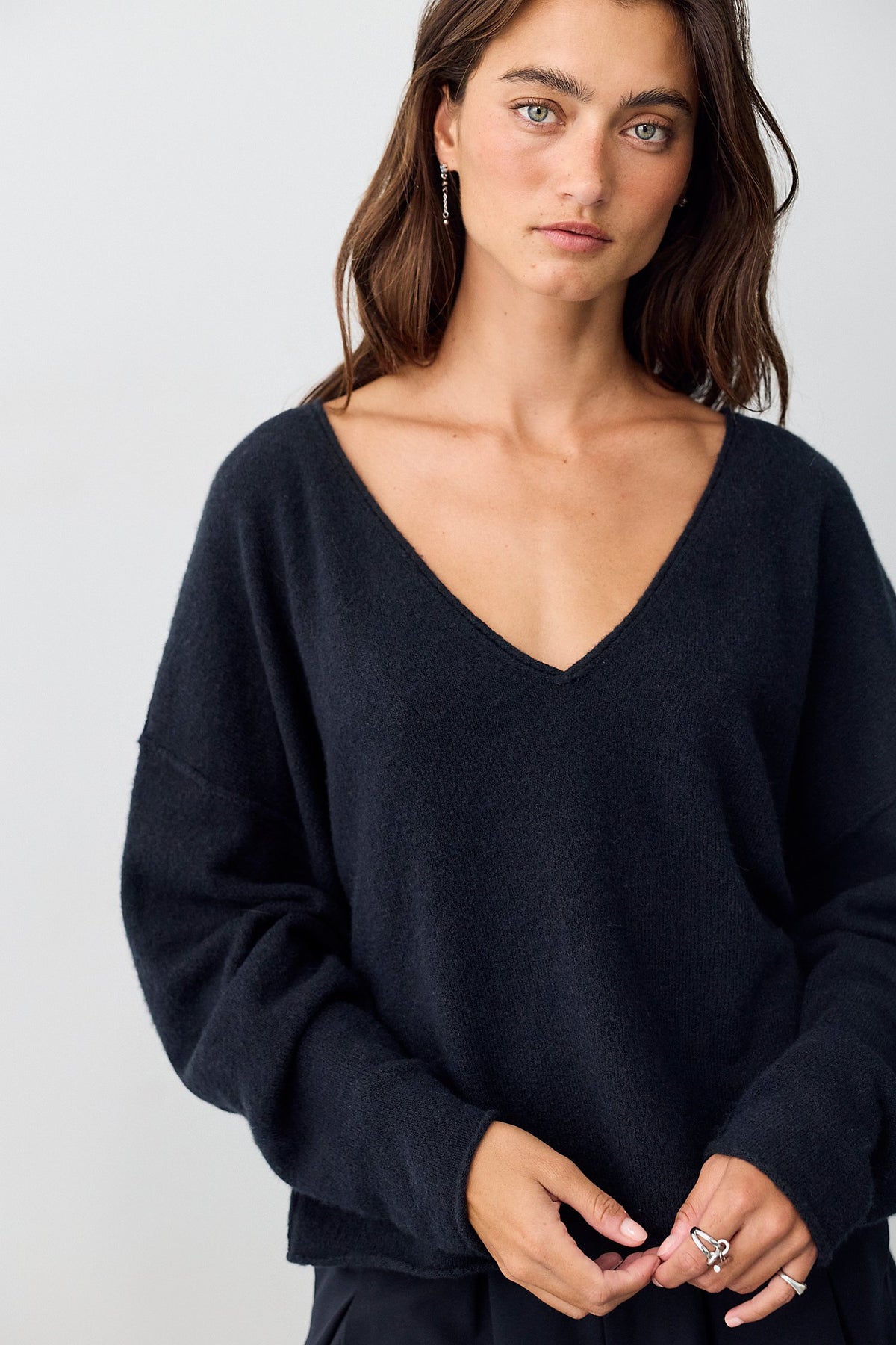 Close-up of the deep V-neckline on the black See Me Pullover