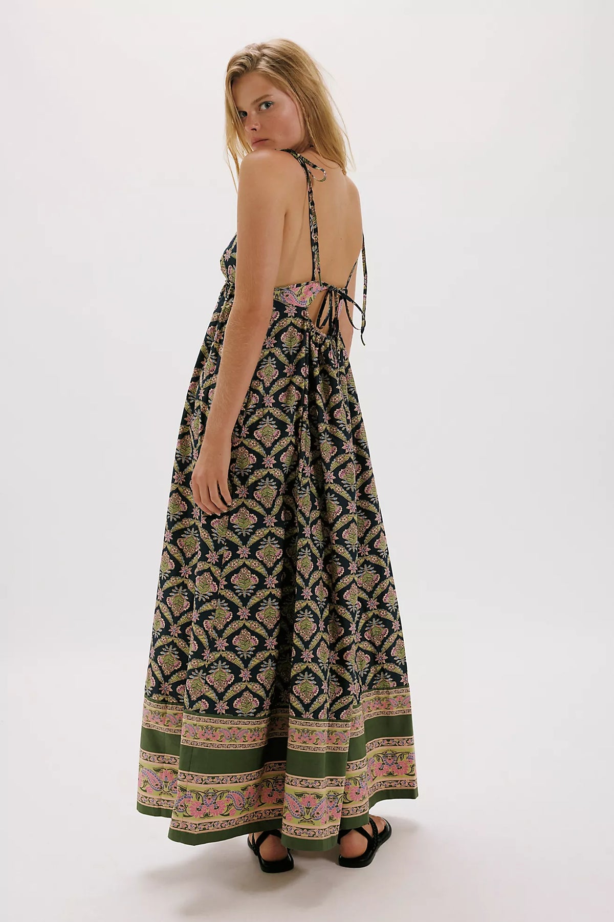 Woman wearing a patterned dress on a white background