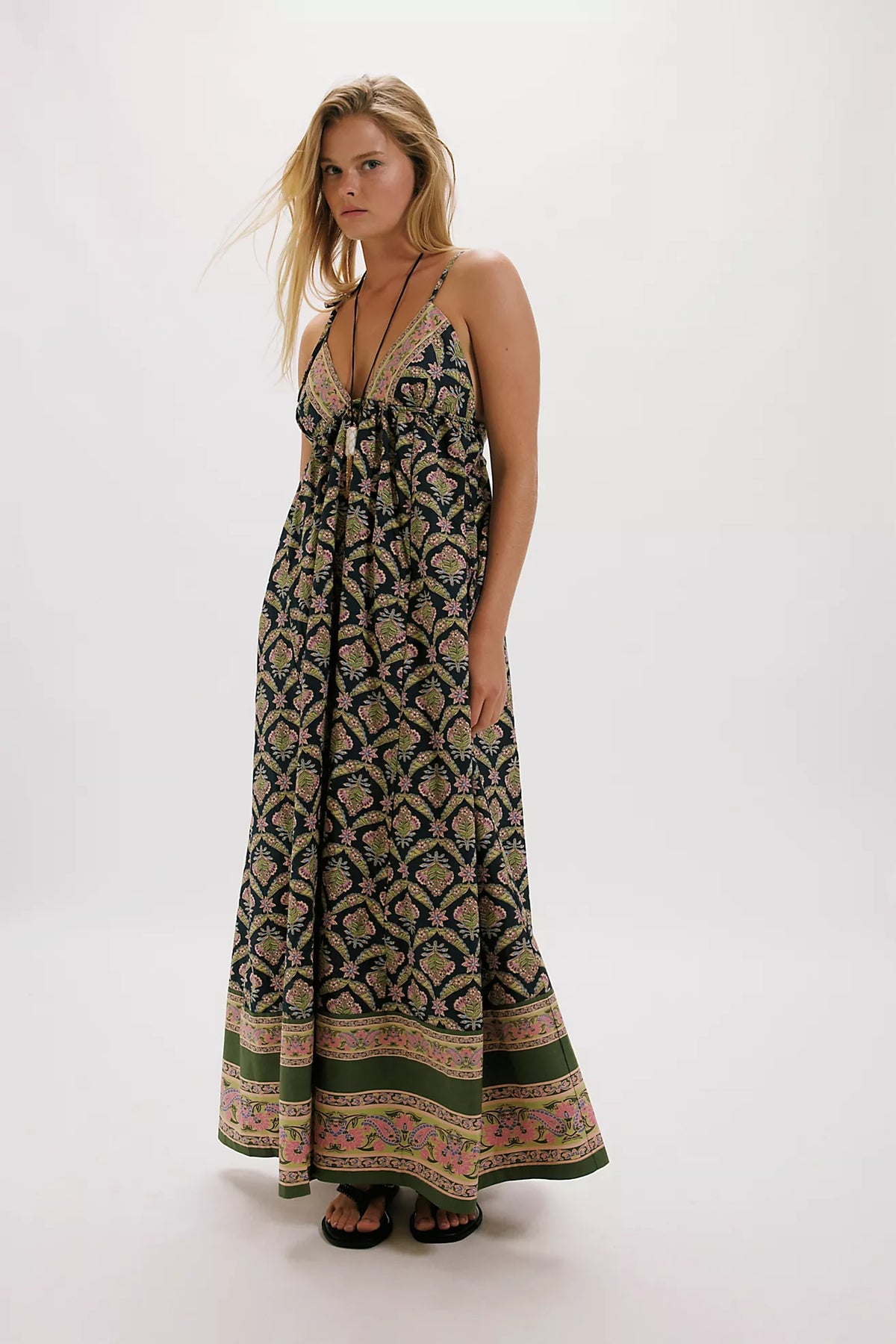 Woman wearing a patterned dress on a white background