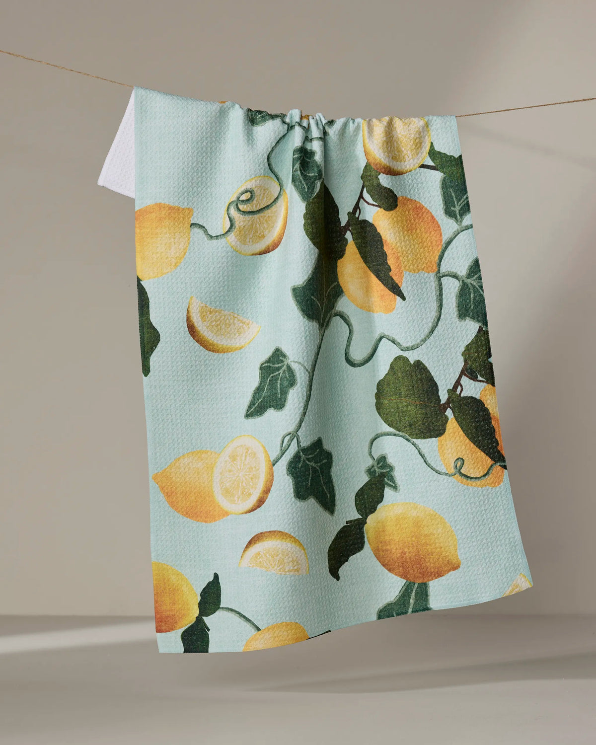 Geometry Amalfi Lemons tea towel laid flat with a bright lemon print