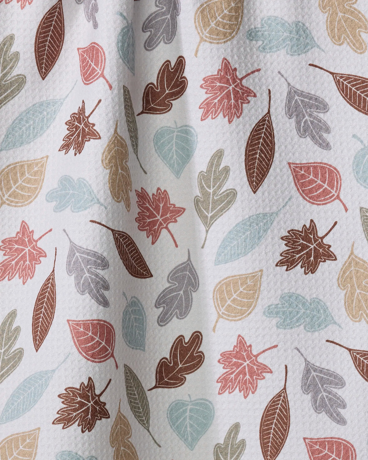 Close-up of the Geometry Harvest Scatter tea towel autumn leaf print in sage, teal, rust and mauve