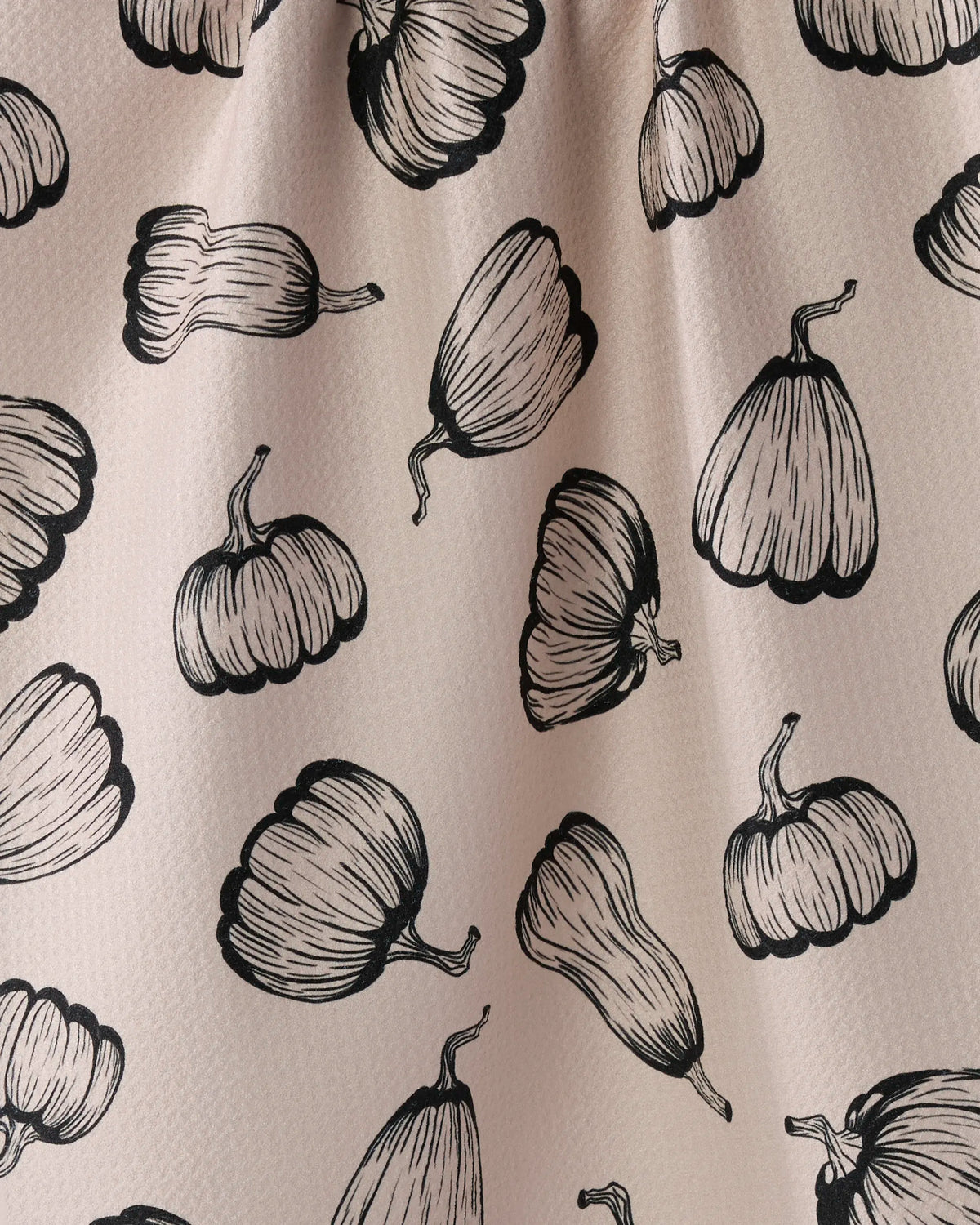 Close-up of the Geometry Hollow Season Halloween tea towel black hand-drawn pumpkins on blush