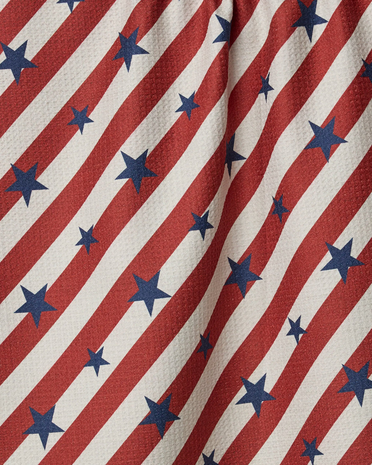 Close-up of the Geometry Patriotic Stripe tea towel showing the red, white and blue stripe print and soft Geoweave texture