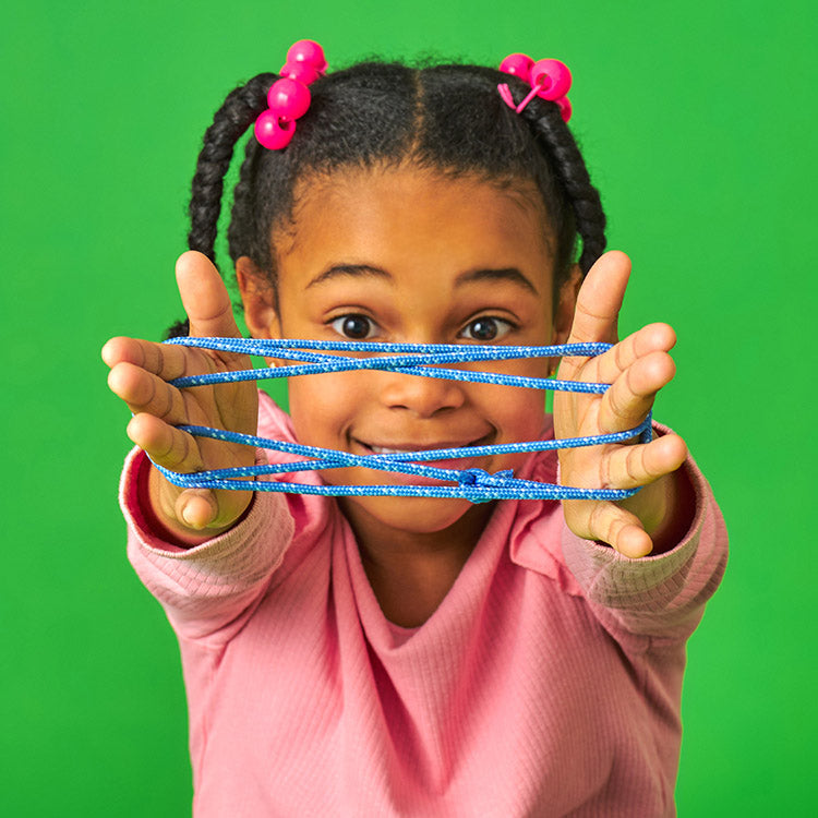 Child playing the Kikkerland cat's cradle string game