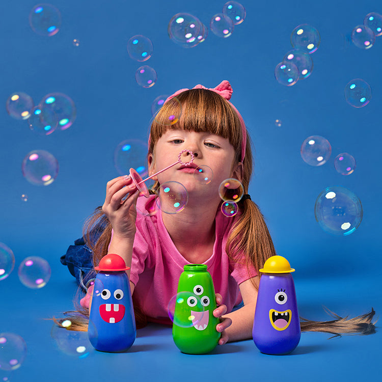 Child blowing bubbles with Kikkerland Kidoki monster bubbles