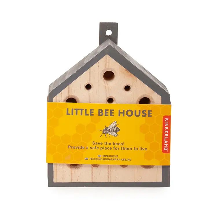 Wooden bee house with a yellow label on a white background