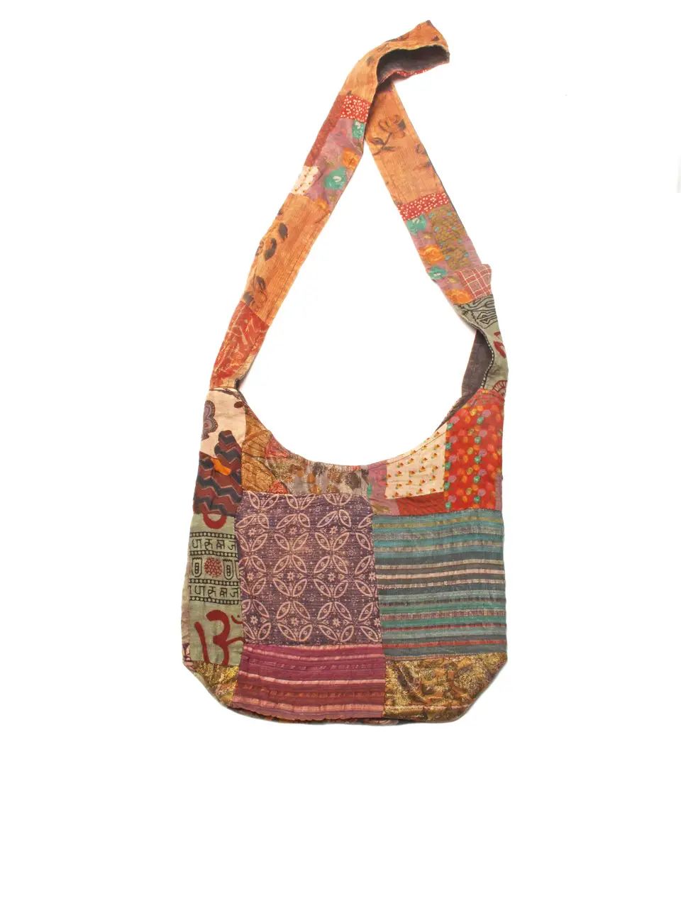 A patchwork quilted shoulder bag with a single strap, featuring various colorful fabric panels in orange, purple, green, and red on a white background.