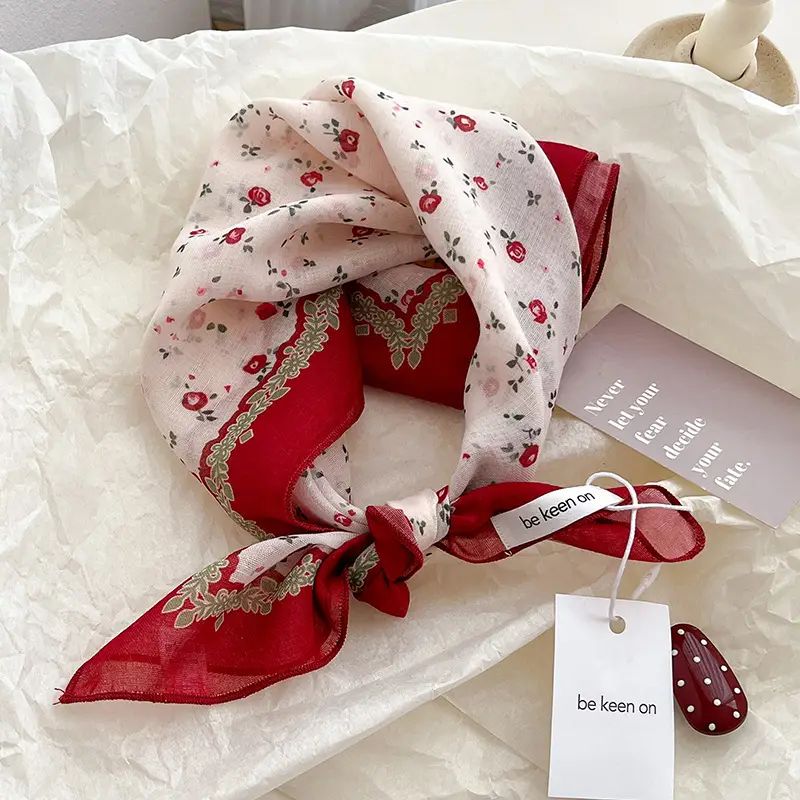 Red and white floral scarf with gold accents on a white background