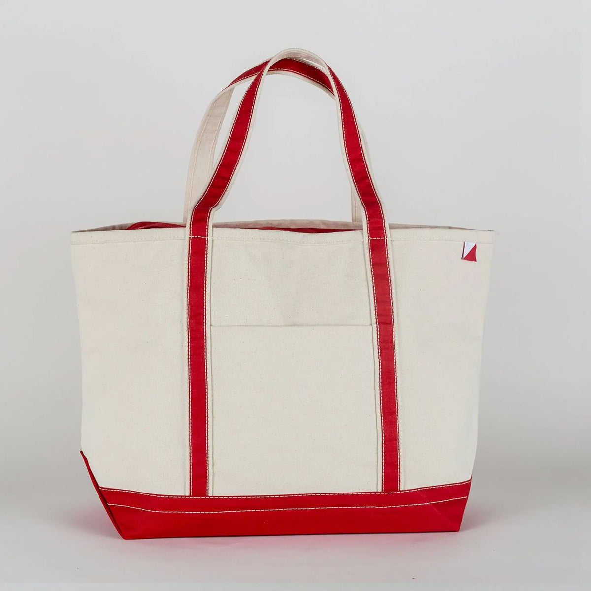 White tote bag with red accents on a white background