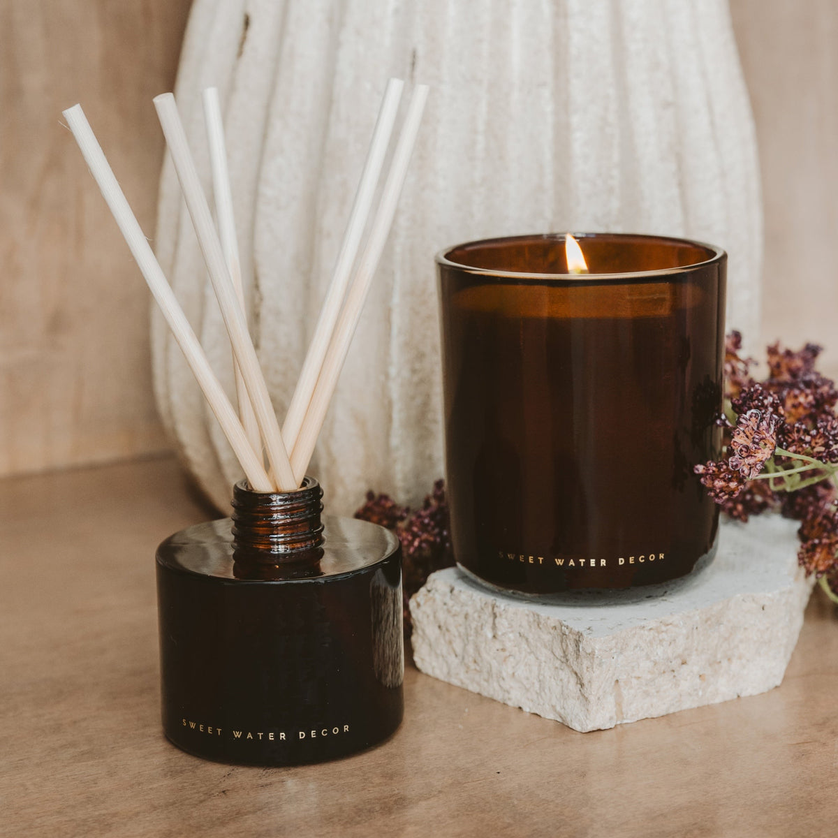 Amber reed diffuser styled with a candle for cozy fall decor