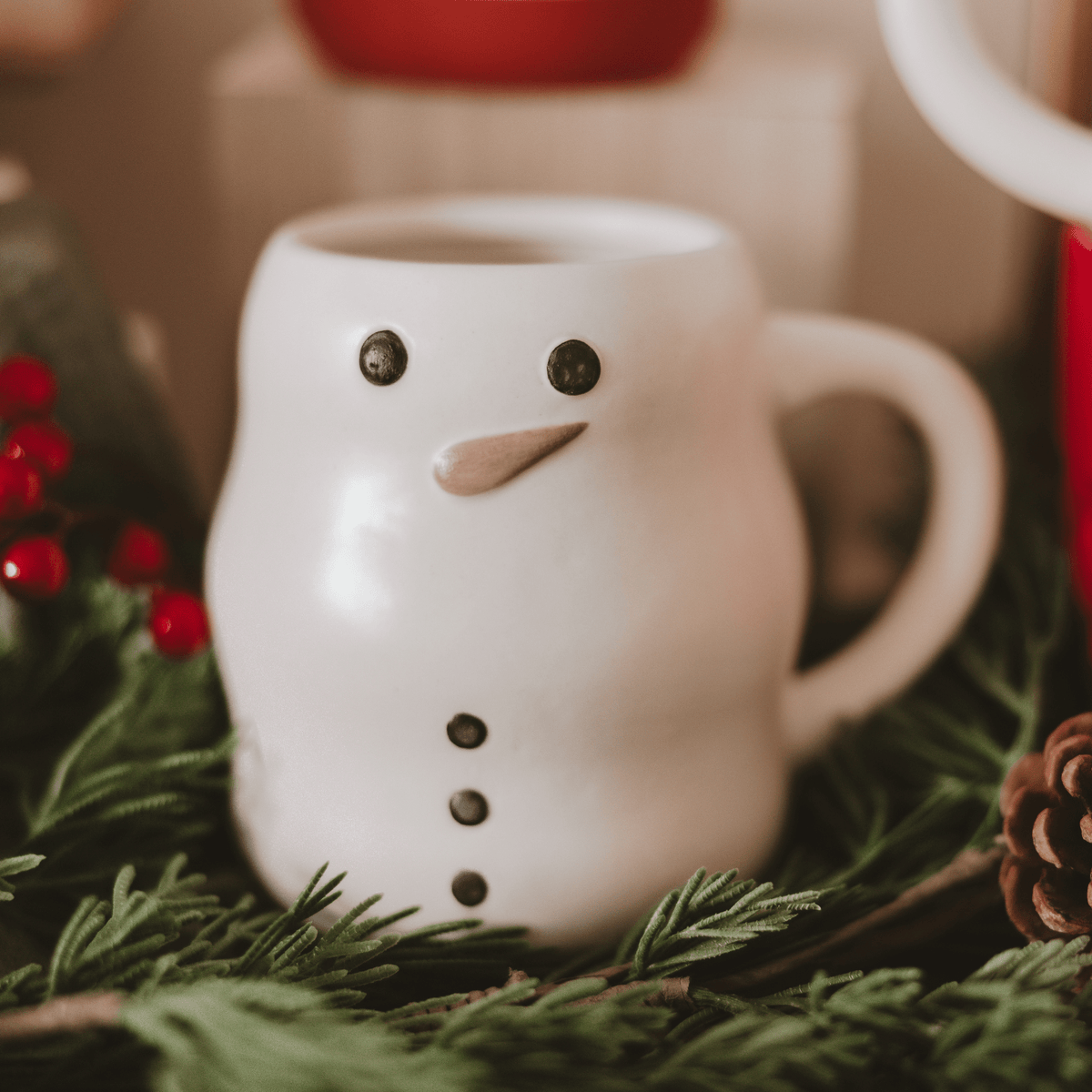 Sweet Water Decor Snowman figurine coffee mug styled with evergreen and holiday lights