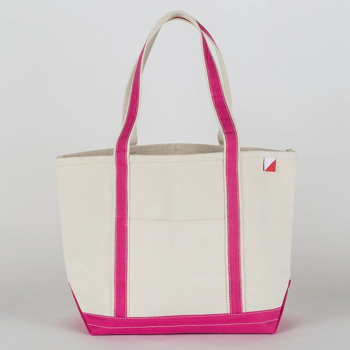 Beige tote bag with pink trim on a white background