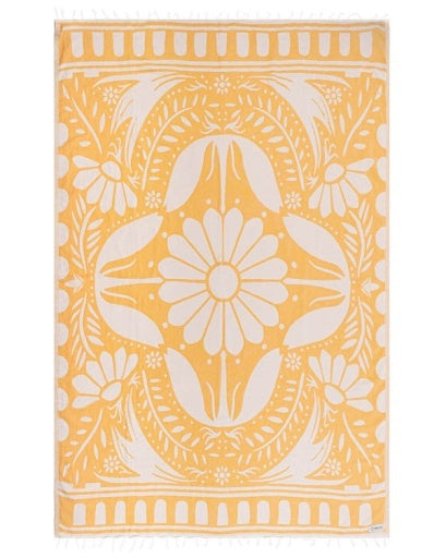 Yellow towel with white floral pattern on a white background