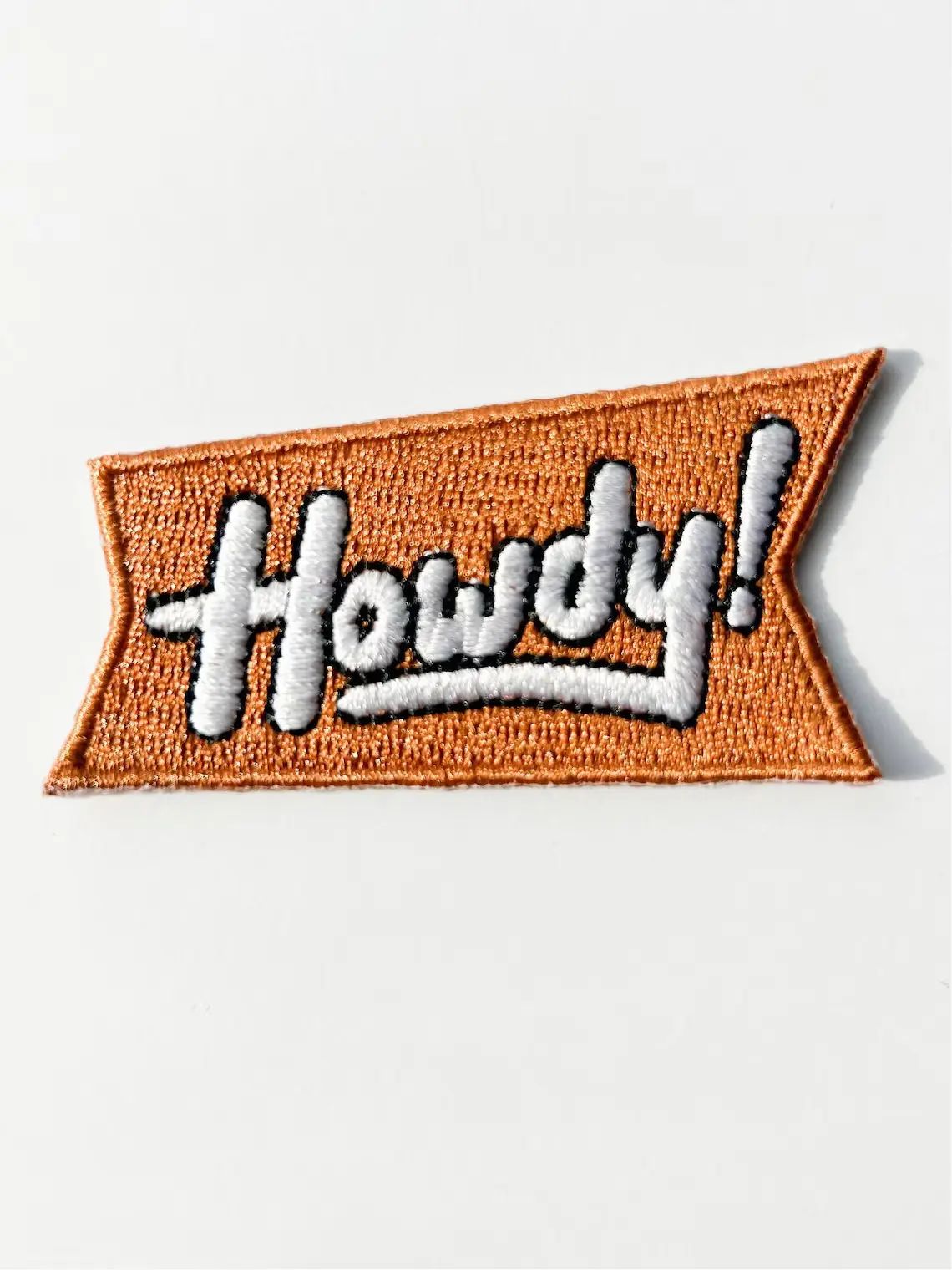 Embroidered patch with 'Howdy!' text on a white background