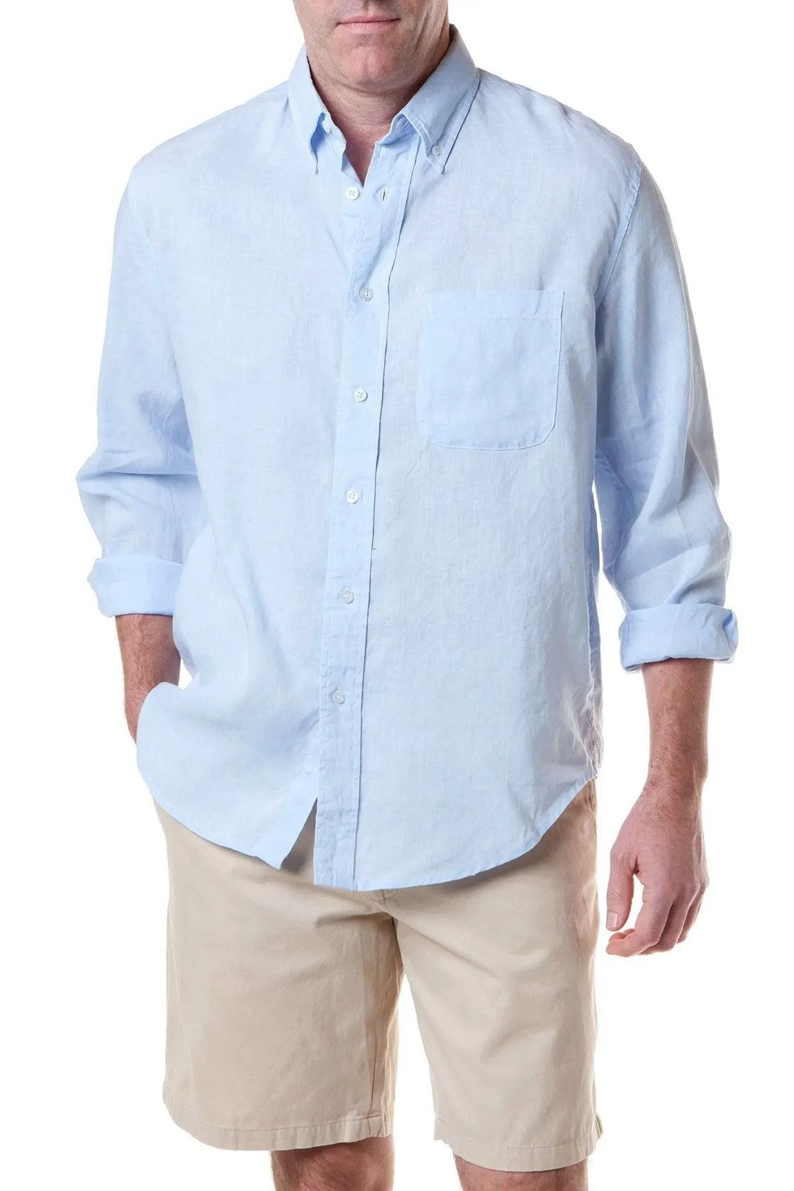 Man wearing a light blue button-up shirt and beige shorts on a white background