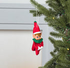 Abbott sitting elf ornament hanging on a Christmas tree