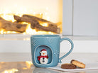 Abbott snowflake mug with snowman styled by the fireplace