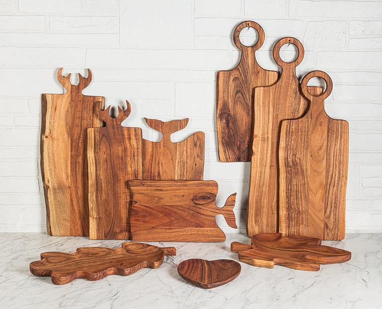 Abbott wood serving boards including the whale tail handle board styled on a counter