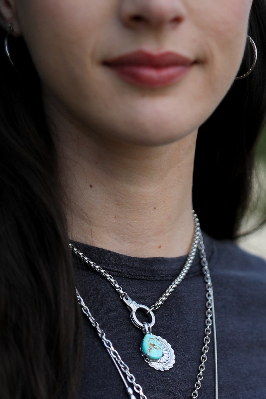 Model wearing the silver Air and Anchor Endgame necklace with a pendant