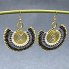Handmade bohemian fan-shaped dangle earrings with gold-tone spiral wire and black, white, and gold beadwork, a unique artisan gift for her