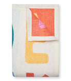 Folded Chappywrap ABC Midi Blanket showing the colorful reversible side