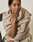 Woman wearing the Chappywrap Bayside Herringbone Shawl in Wheat