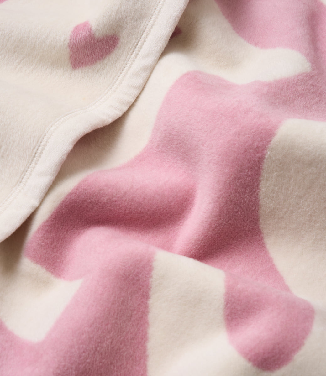 Close-up of the heart pattern and soft knit on the Chappywrap Big Sis Midi Blanket