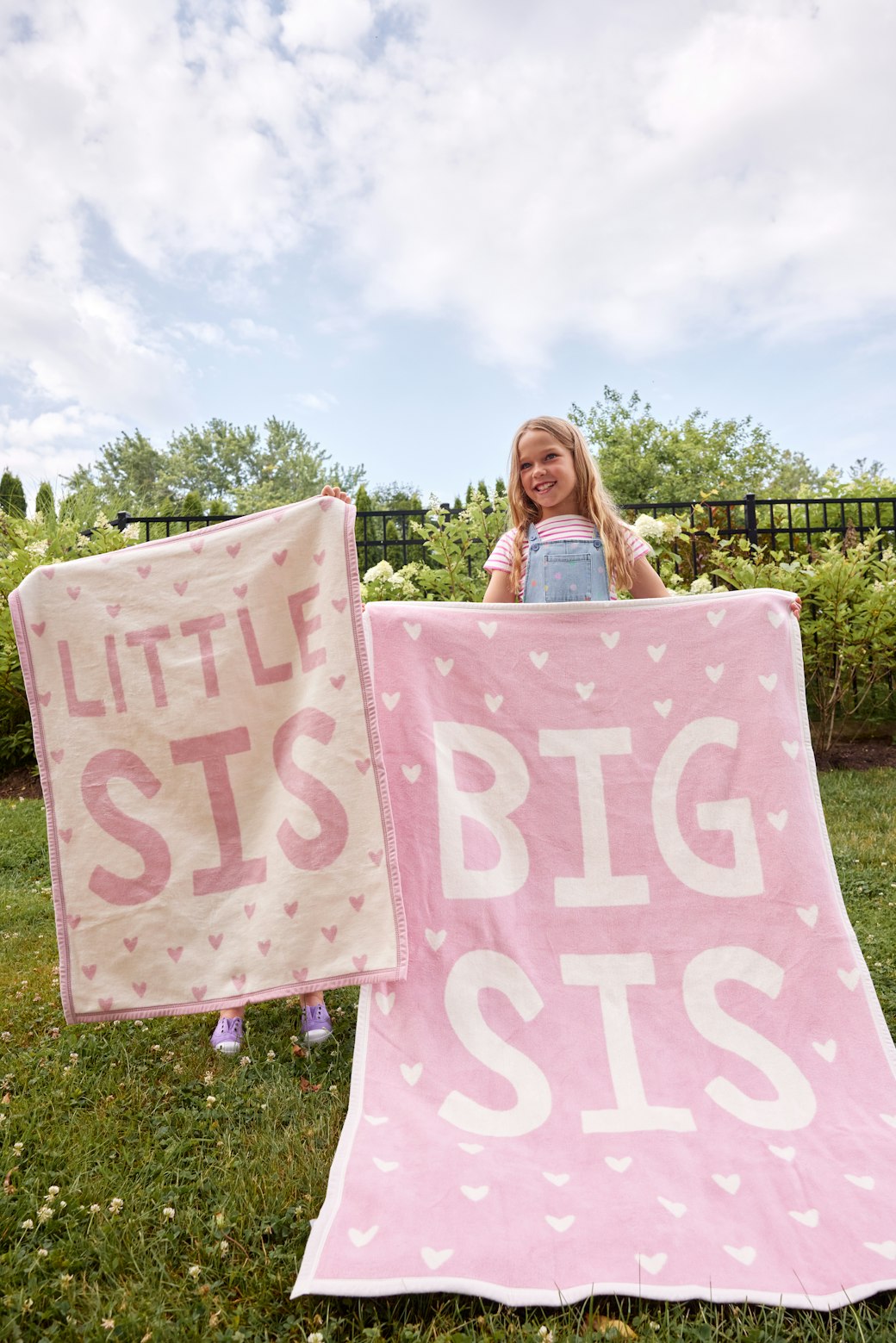 Sisters holding the Chappywrap Big Sis and Little Sis blankets outdoors