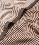 Close-up of the herringbone knit and border on the Harborview Herringbone Midi Blanket in Chocolate