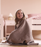 Girl wrapped in the Chappywrap Harborview Herringbone Midi Blanket in Chocolate