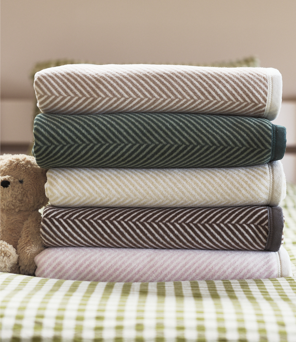 Stack of folded Chappywrap Harborview Herringbone blankets including Forest Green