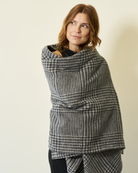 Woman wearing the Chappywrap Katama Plaid Shawl in Ash wrapped around her shoulders