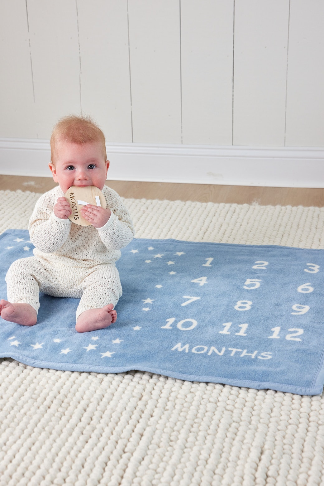 Baby sitting on the Chappywrap Milestone Mini Blanket in Fog for a monthly milestone photo