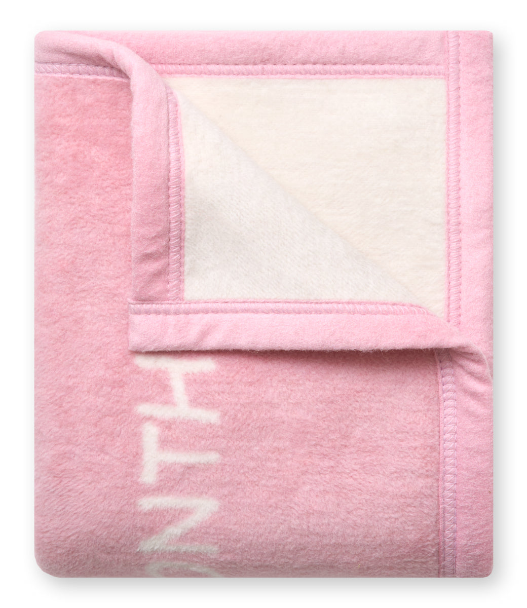 Folded Chappywrap Milestone Mini Blanket in Blush showing the reversible cream side