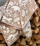 Chappywrap Whimsical Woods Blanket in Sepia draped outdoors, showing the woodland pattern