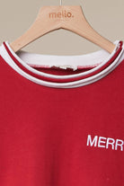 Close-up of the red sweatshirt neckline with white contrast tipping and embroidered Merry detail